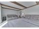 Open concept living room featuring neutral carpeting and exposed wood beams on the ceiling at 1772 Woodridge Pl, Greenwood, IN 46143