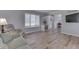 Bright living room with light wood floors, large window, and comfortable seating at 1772 Woodridge Pl, Greenwood, IN 46143
