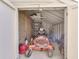 View into the shed showing a lawn mower and gardening tools neatly stored inside at 1772 Woodridge Pl, Greenwood, IN 46143