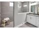 Modern bathroom featuring a glass-enclosed shower, gray tile and a white vanity with sleek black hardware at 19414 Mcbee Ave, Westfield, IN 46074
