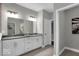 Modern bathroom with double sink vanity, gray tile flooring, and bright lighting fixtures at 19414 Mcbee Ave, Westfield, IN 46074