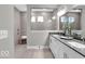 Modern bathroom with double vanity, tiled shower, and neutral color palette at 19414 Mcbee Ave, Westfield, IN 46074