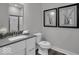 Bathroom featuring a sleek vanity, modern fixtures, toilet, and framed decor at 19414 Mcbee Ave, Westfield, IN 46074