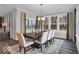 Bright dining room with large windows, wood table, chandelier, and neutral decor at 19414 Mcbee Ave, Westfield, IN 46074