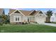 Charming single-story home with gray siding, complemented by a well-manicured lawn and inviting landscaping at 19414 Mcbee Ave, Westfield, IN 46074