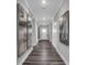 Long hallway with elegant flooring, artwork, and stylish lighting at 19414 Mcbee Ave, Westfield, IN 46074