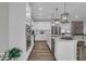 Contemporary kitchen with white cabinetry, stainless steel appliances, and a center island at 19414 Mcbee Ave, Westfield, IN 46074