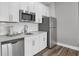 Modern kitchen featuring stainless steel appliances, white cabinets, and subway tile backsplash at 19414 Mcbee Ave, Westfield, IN 46074
