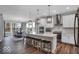 Modern kitchen featuring a large island with seating, stainless steel appliances and open floorplan at 19414 Mcbee Ave, Westfield, IN 46074