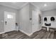 Functional mudroom with wood-look flooring, white trim, convenient bench and coat hooks, and exterior doors at 19414 Mcbee Ave, Westfield, IN 46074
