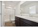 Modern bathroom showcasing a double vanity, white countertops, and glass-enclosed shower at 1976 White Oak Ln, Shelbyville, IN 46176