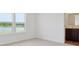 Bedroom with a view of a pond and adjacent bathroom featuring modern vanity and lighting at 1976 White Oak Ln, Shelbyville, IN 46176