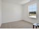 Cozy bedroom with neutral carpet, bright natural light, and a view of the neighborhood at 1976 White Oak Ln, Shelbyville, IN 46176