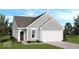 Charming single-Gathering home featuring gray siding, a two-car garage, and a well-manicured lawn at 1976 White Oak Ln, Shelbyville, IN 46176