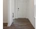 Entryway with wood-look flooring, white trim, and a white door showcasing the home's interior at 1976 White Oak Ln, Shelbyville, IN 46176