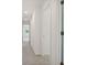 Hallway featuring neutral carpet and white trim throughout the well-lit, open space at 1976 White Oak Ln, Shelbyville, IN 46176