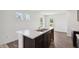 Kitchen island with a stainless steel sink and white countertops, set in a white-walled room at 1976 White Oak Ln, Shelbyville, IN 46176