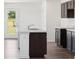 Modern kitchen island with white countertop, dark cabinets, and a stainless steel sink at 1976 White Oak Ln, Shelbyville, IN 46176