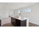 View of the kitchen featuring a central island with light countertops and neutral walls at 1976 White Oak Ln, Shelbyville, IN 46176