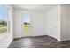 Bright living room with stylish gray floors and a back door leading to a view of the water at 1976 White Oak Ln, Shelbyville, IN 46176