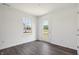 Bright room featuring dark wood floors and a glass door leading outside at 1976 White Oak Ln, Shelbyville, IN 46176