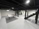 Finished basement area featuring a ping pong table, painted floors, and exposed rafters at 2029 Winton Ave, Indianapolis, IN 46224