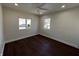 Cozy bedroom with hardwood floors, ceiling fan and two windows offering plenty of natural light at 2029 Winton Ave, Indianapolis, IN 46224