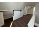 Upstairs bonus room with hardwood floors and sliding door to a storage area at 2029 Winton Ave, Indianapolis, IN 46224