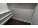 Walk-in closet with built-in shelving and wooden rod for clothes storage, providing an organized space at 2029 Winton Ave, Indianapolis, IN 46224
