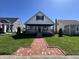 Inviting two-story home with a cozy front porch, brick walkway, and well-maintained lawn at 2029 Winton Ave, Indianapolis, IN 46224