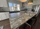 Open kitchen with stainless steel appliances, a granite island, and modern fixtures with great light at 2029 Winton Ave, Indianapolis, IN 46224