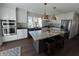 Bright, modern kitchen features stainless steel appliances, a large island, and stylish pendant lighting at 2029 Winton Ave, Indianapolis, IN 46224
