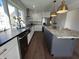 Bright kitchen featuring stainless steel appliances, granite counters, and an island with seating at 2029 Winton Ave, Indianapolis, IN 46224