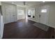 Open-concept living room featuring beautiful hardwood floors, an updated ceiling fan, and natural light at 2029 Winton Ave, Indianapolis, IN 46224