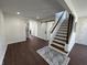 Beautiful living room with hardwood floors, staircase access, and natural light at 2029 Winton Ave, Indianapolis, IN 46224