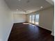 Open living room with wood floors and sliding glass doors leading to outdoor area with lots of light at 2029 Winton Ave, Indianapolis, IN 46224