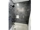 Updated shower with white subway tiles and a shower head at 2029 Winton Ave, Indianapolis, IN 46224