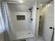 Updated shower features white subway tile surround with rain shower head and glass tile niche at 2029 Winton Ave, Indianapolis, IN 46224