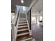 Traditional staircase with hardwood treads and white risers leading to the second floor at 2029 Winton Ave, Indianapolis, IN 46224