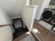 Shot of the staircase leading down to the basement, featuring hardwood floors and new grey paint at 2029 Winton Ave, Indianapolis, IN 46224