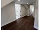 Upstairs hallway featuring hardwood floors and doors leading to bathrooms and bedrooms at 2029 Winton Ave, Indianapolis, IN 46224