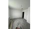 Bedroom shows concrete floors, fresh white paint and trim, and an interior door, ready for new flooring at 2157 S Meridian St, Indianapolis, IN 46225