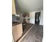 Unfinished kitchen features wood-look flooring, natural wood cabinets, and a window, awaiting completion at 2157 S Meridian St, Indianapolis, IN 46225