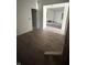 Large living room with freshly installed dark wood-look flooring, neutral walls, and an open floor plan at 2157 S Meridian St, Indianapolis, IN 46225