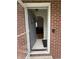 Exterior view of a brick home featuring an open front door at 216 Golf Club Rd, Anderson, IN 46011