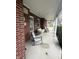 Inviting front porch with comfortable seating and brick facade at 216 Golf Club Rd, Anderson, IN 46011