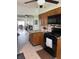 Open-concept kitchen featuring wood cabinets, a peninsula, and an open view to the living area at 216 Golf Club Rd, Anderson, IN 46011