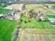 Expansive aerial view of a property featuring green lawns, fields, and buildings at 2215 W State Rd, Pendleton, IN 46064