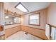 Bright bathroom with a window, a skylight, wainscoting, and a large mirror at 2215 W State Rd, Pendleton, IN 46064