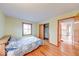 Cozy bedroom with wood floors, view from a window, and an open closet provides ample storage space at 2215 W State Rd, Pendleton, IN 46064